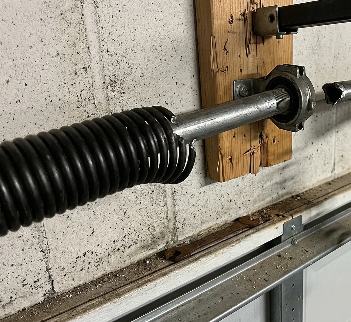 Broken garage door torsion spring showing common failure patterns